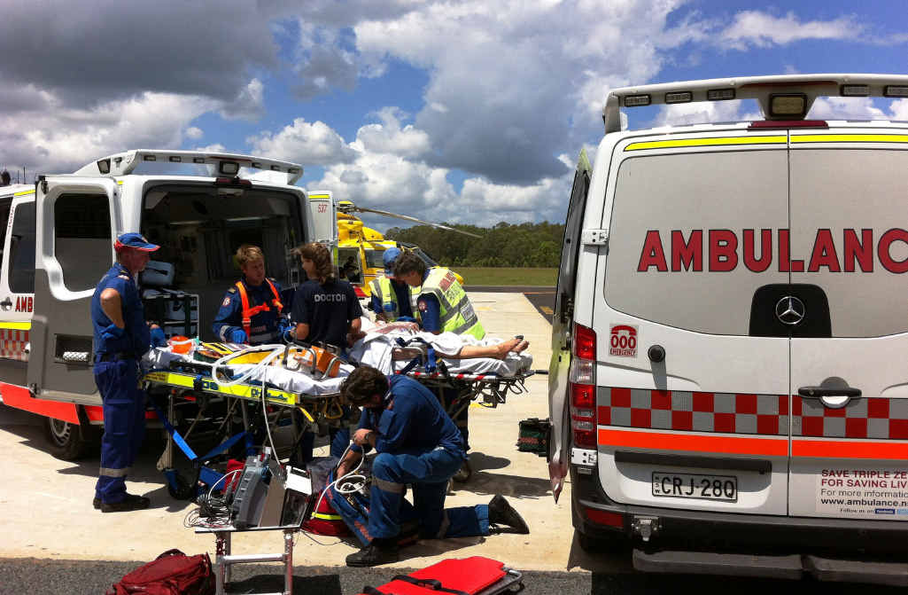 URGENT WORK: Paramedics and Westpac Chopper crew prepare the woman for the flight to hospital. Photo: Contributed URGENT WORK: Paramedics and Westpac Chopper crew prepare the woman for the flight to hospital. Photo: Contributed
